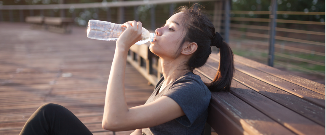 Person drinking water with visible relief from joint pain, emphasizing the benefits of hydration